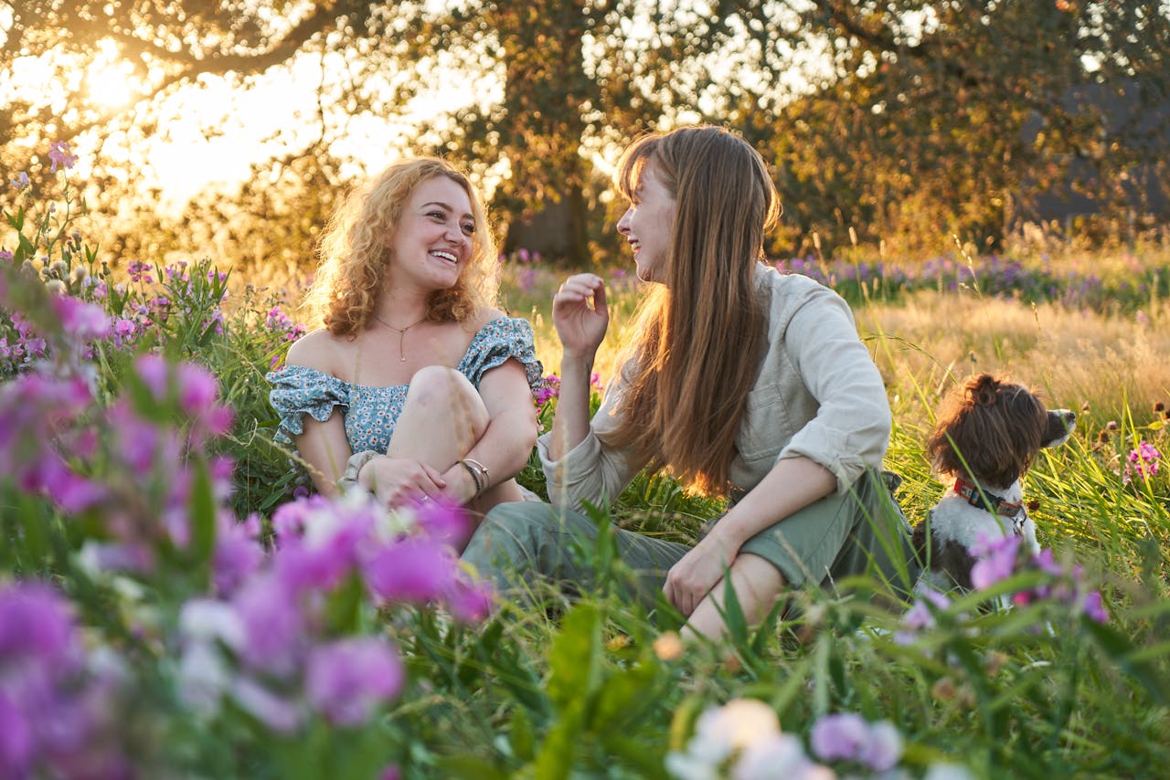 Women Sitting and Talking on Grass