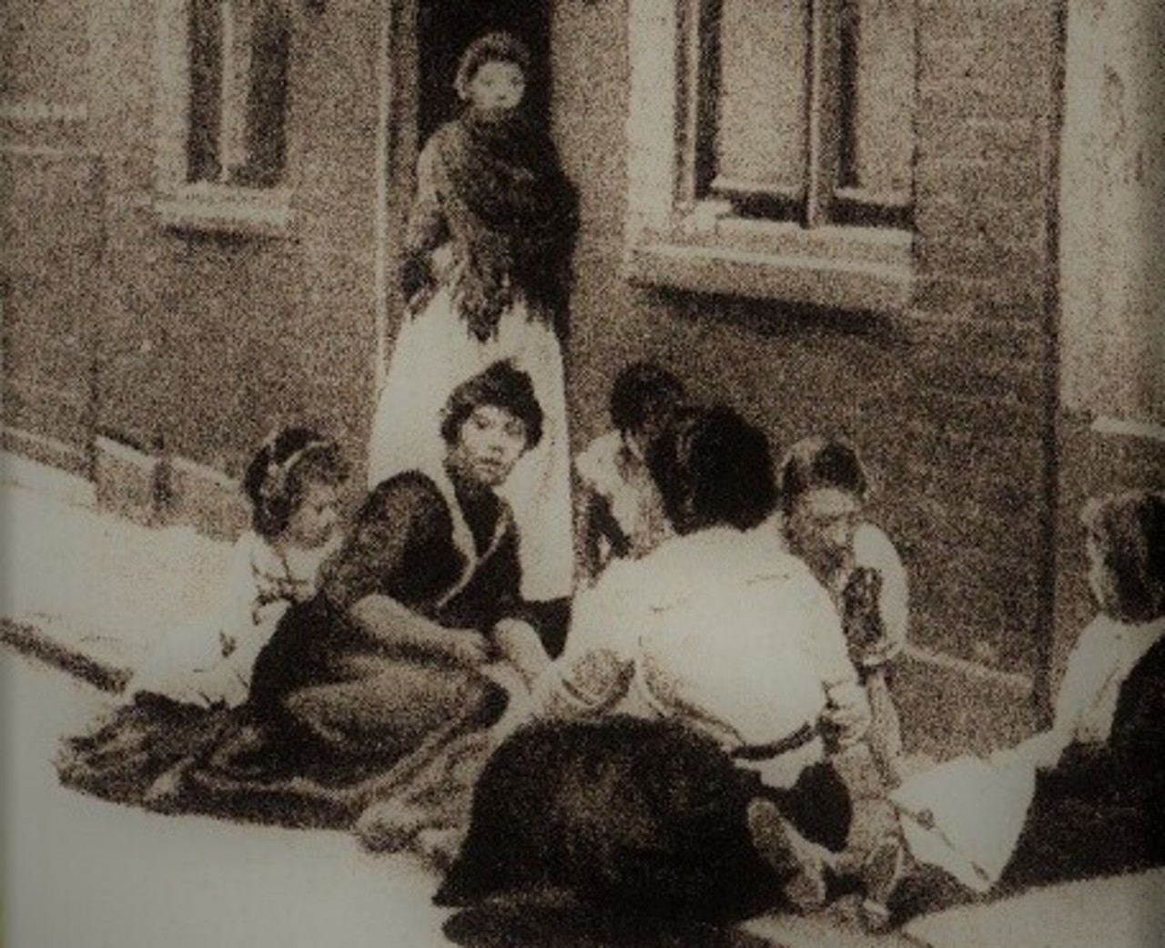 Women and children congregate in front of one of the Whitechapel common lodging-houses close to where Jack the Ripper murdered two of his victims