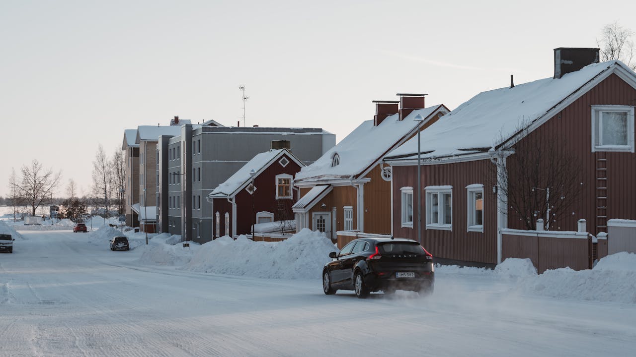 Car on Street in Snow in Village
