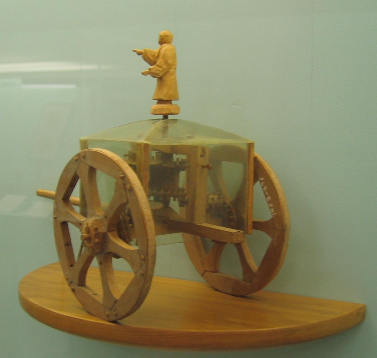 Exhibit in the Science Museum in London, England. This conjectural model chariot incorporates a differential gear.