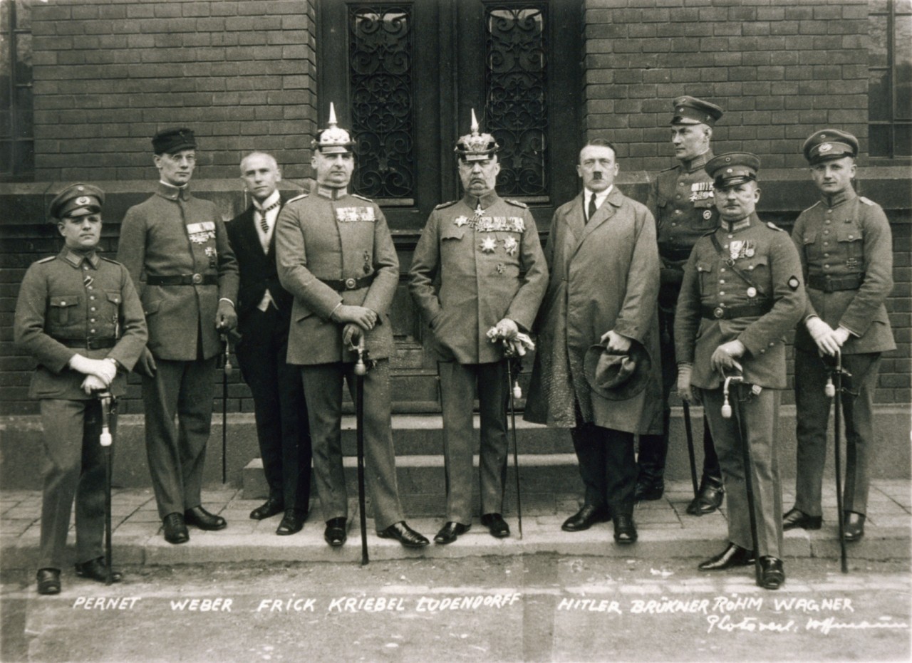 Defendants in the Beer Hall Putsch trial, 1 April 1924. From left to right: Heinz Pernet, Friedrich Weber, Wilhelm Frick, Hermann Kriebel, Erich Ludendorff, Hitler, Wilhelm Brückner, Ernst Röhm, and Robert Wagner