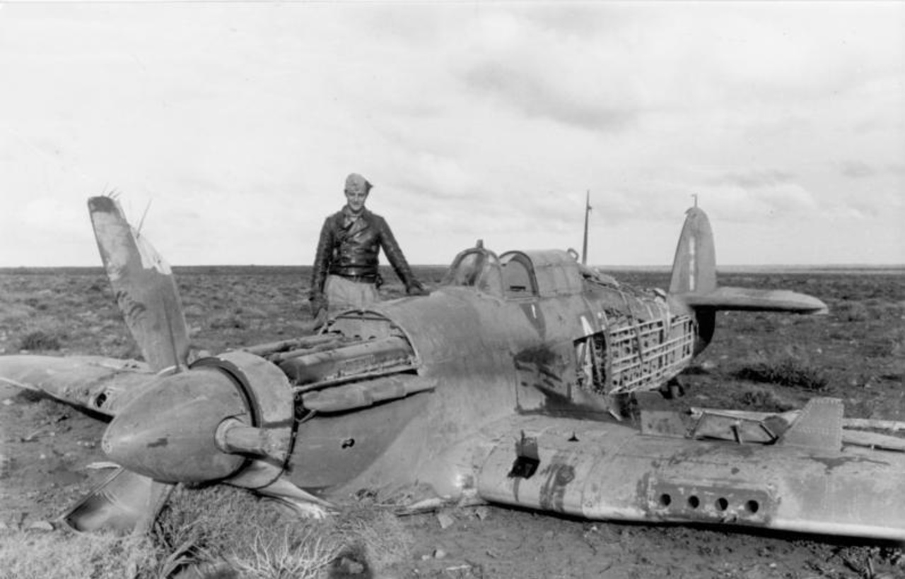 Hans-Joachim Marseille standing next to one of his aerial victories