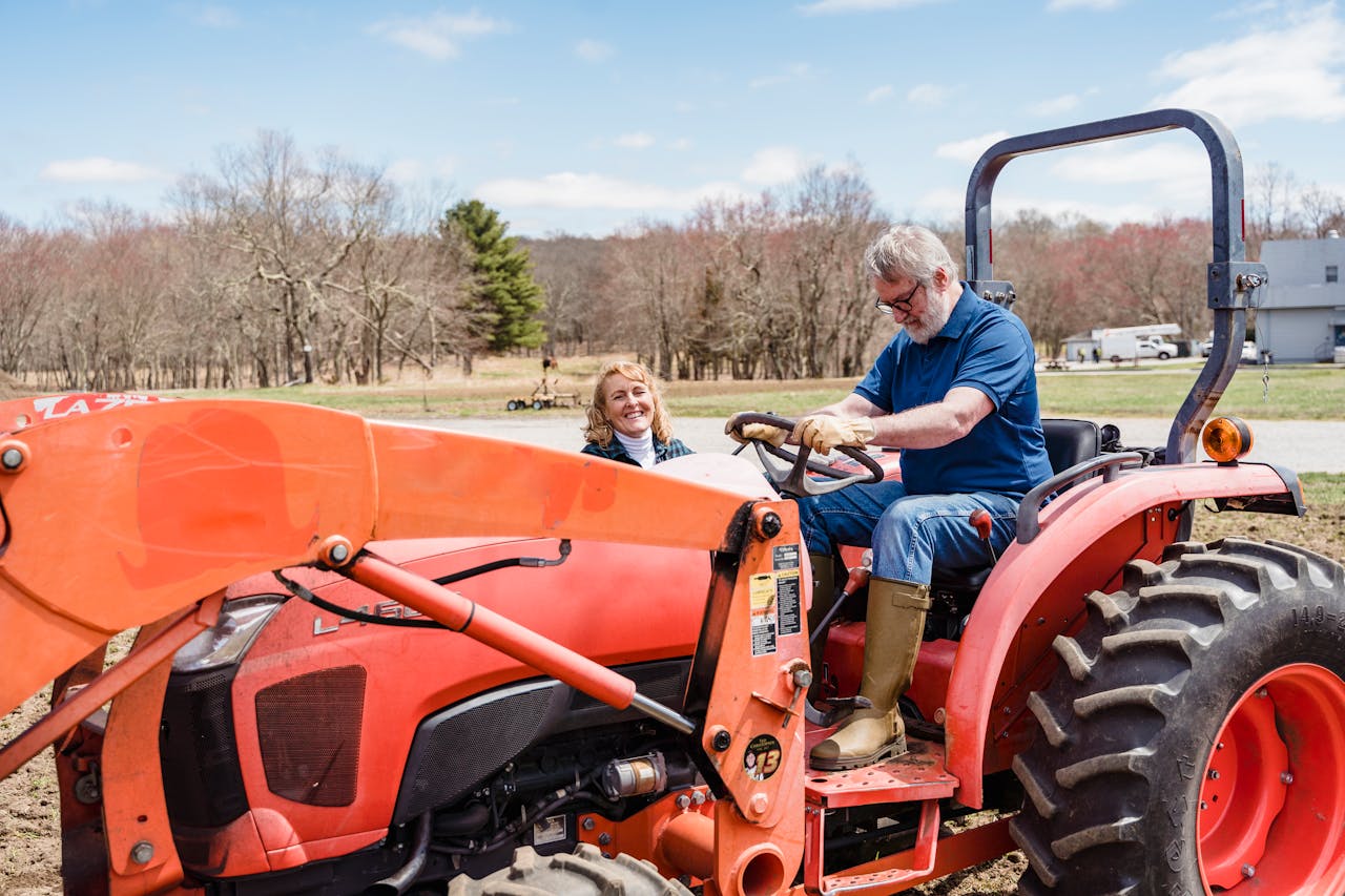Elderly Man Driving a Tractor
