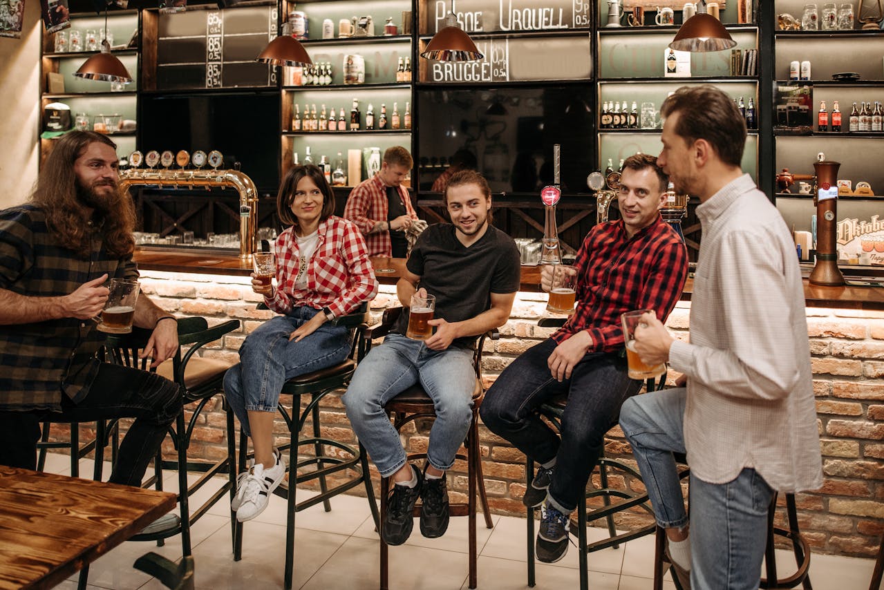 Friends Talking at Counter in Bar

