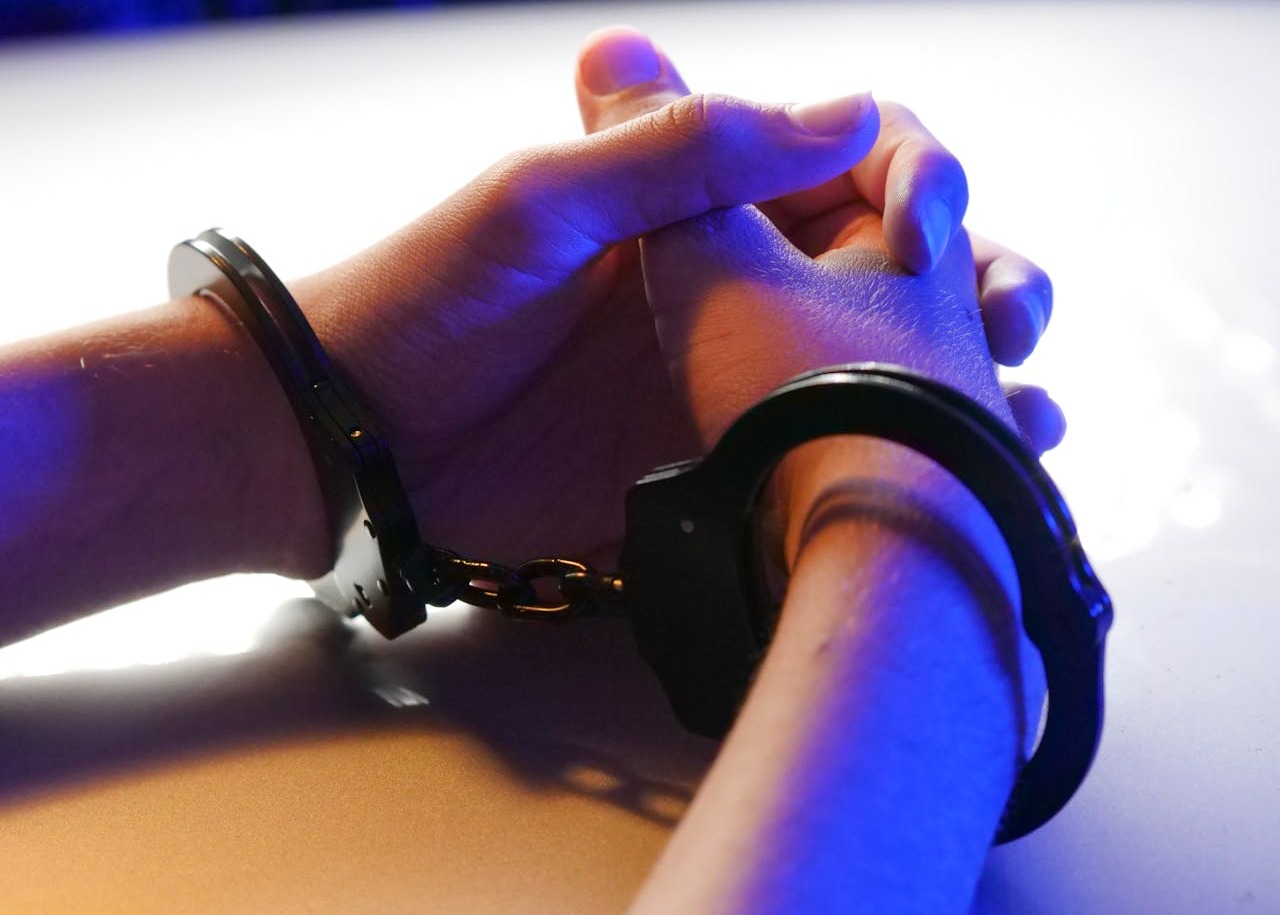 A Person with Black Handcuffs