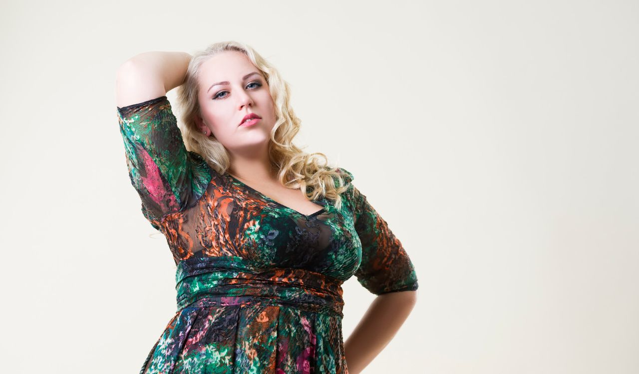 Plus size fashion model, fat woman on beige studio background, overweight female body