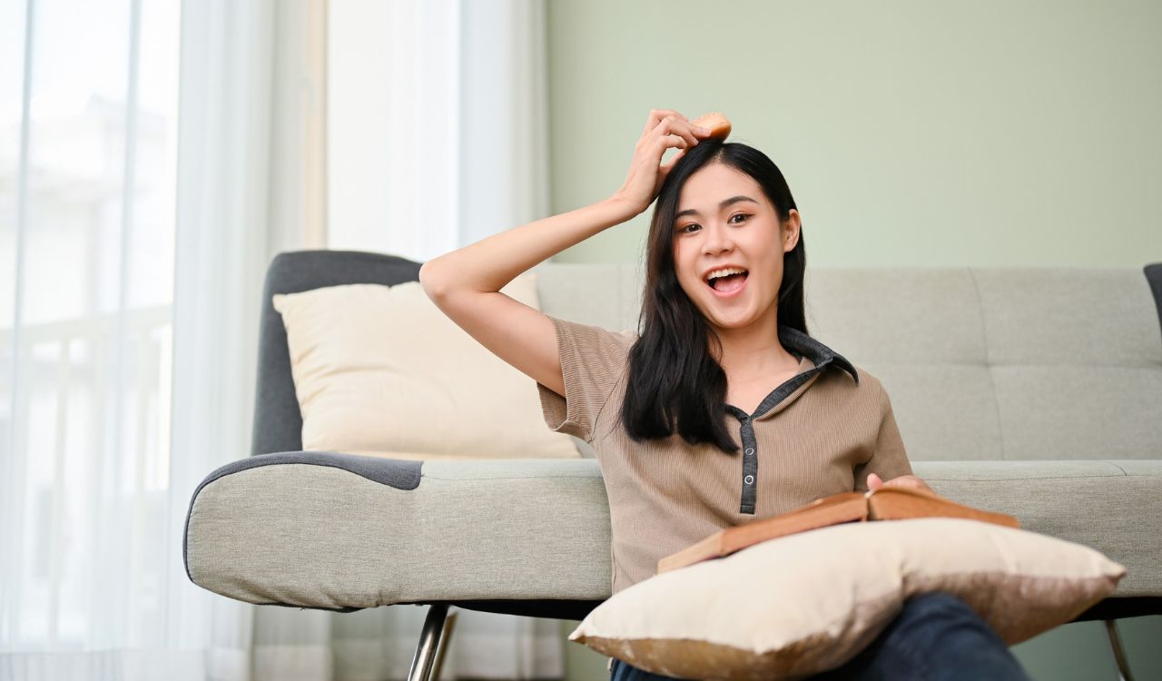 WeddingTraditions_MaliHenna_DeniseStephanie_002RZ joyful and happy young Asian female in casual clothes enjoying doing her hobby on the weekend in her living room, reading a book and snacking.
