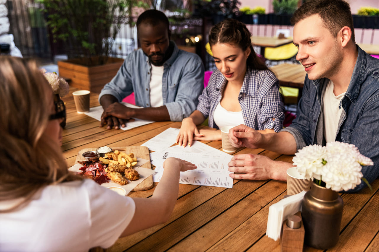A table of diners discussing their orders