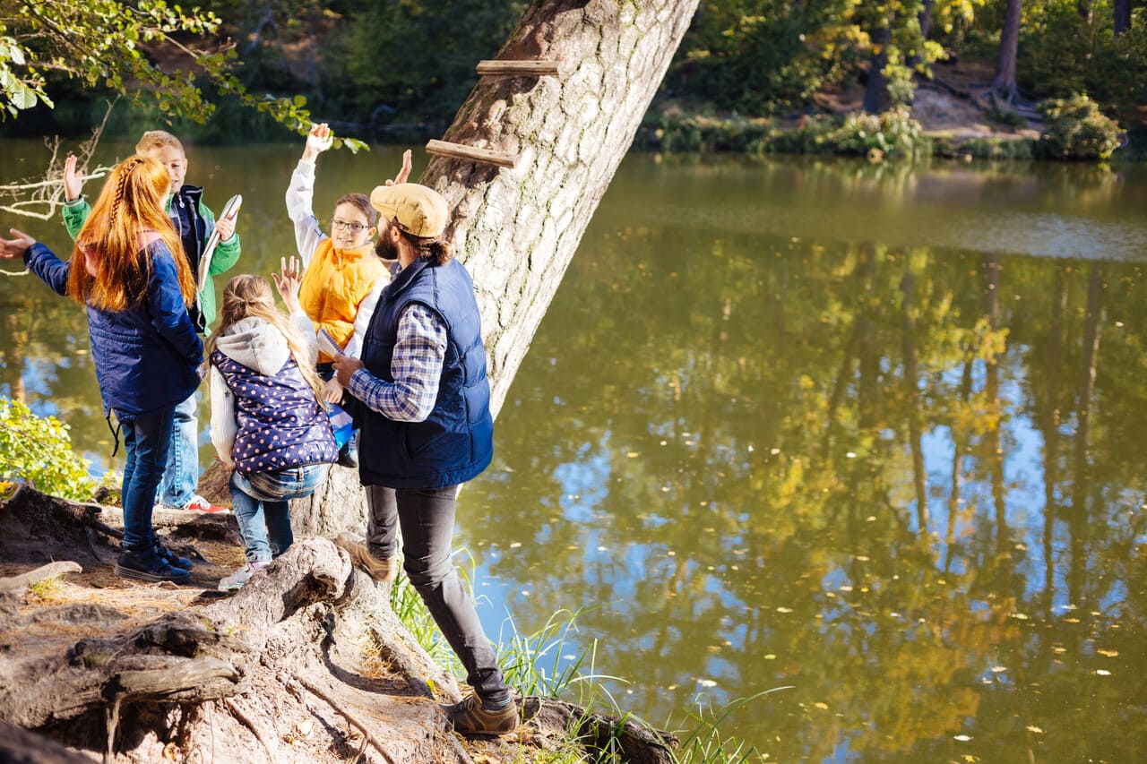 Students outdoors with notebooks identifying leaves at a local park or pond, with a warm, slightly grainy vintage finish.