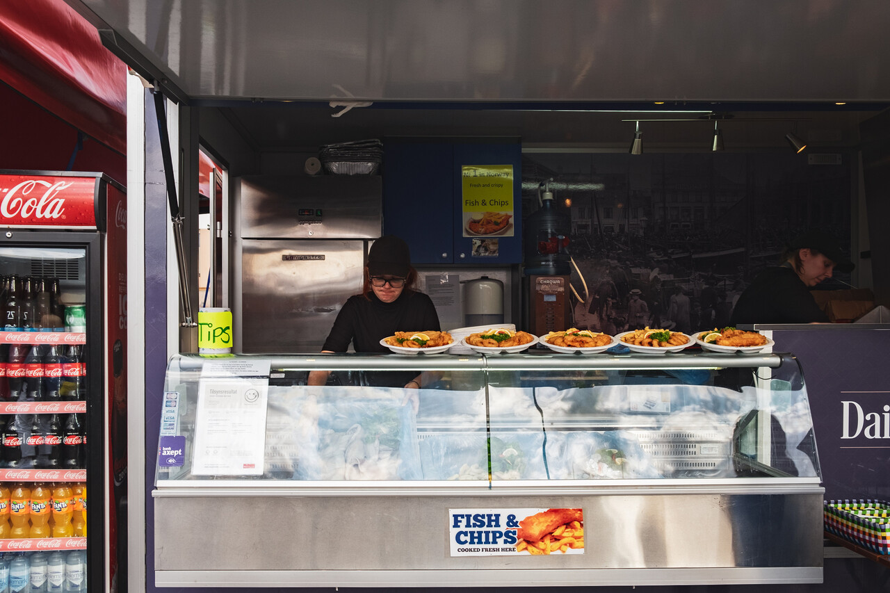 A food truck window with a visible inspection grade sign.