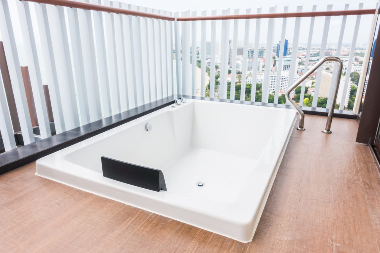 spa disconnect box mounted near a hot tub.