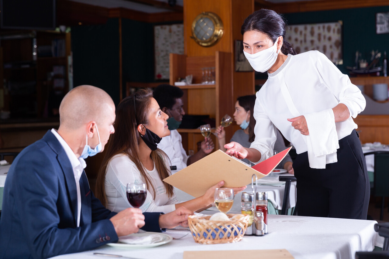 A guest smiling or nodding in response to a server’s suggestion