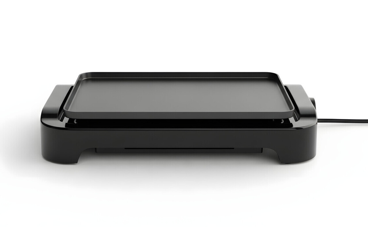 A sleek, modern black electric tabletop griddle or teppanyaki grill, shown from the front on a white background. The square, non-stick cooking surface is clean and empty. This kitchen appliance is used for cooking a variety of foods like pancakes, eggs, and burgers.