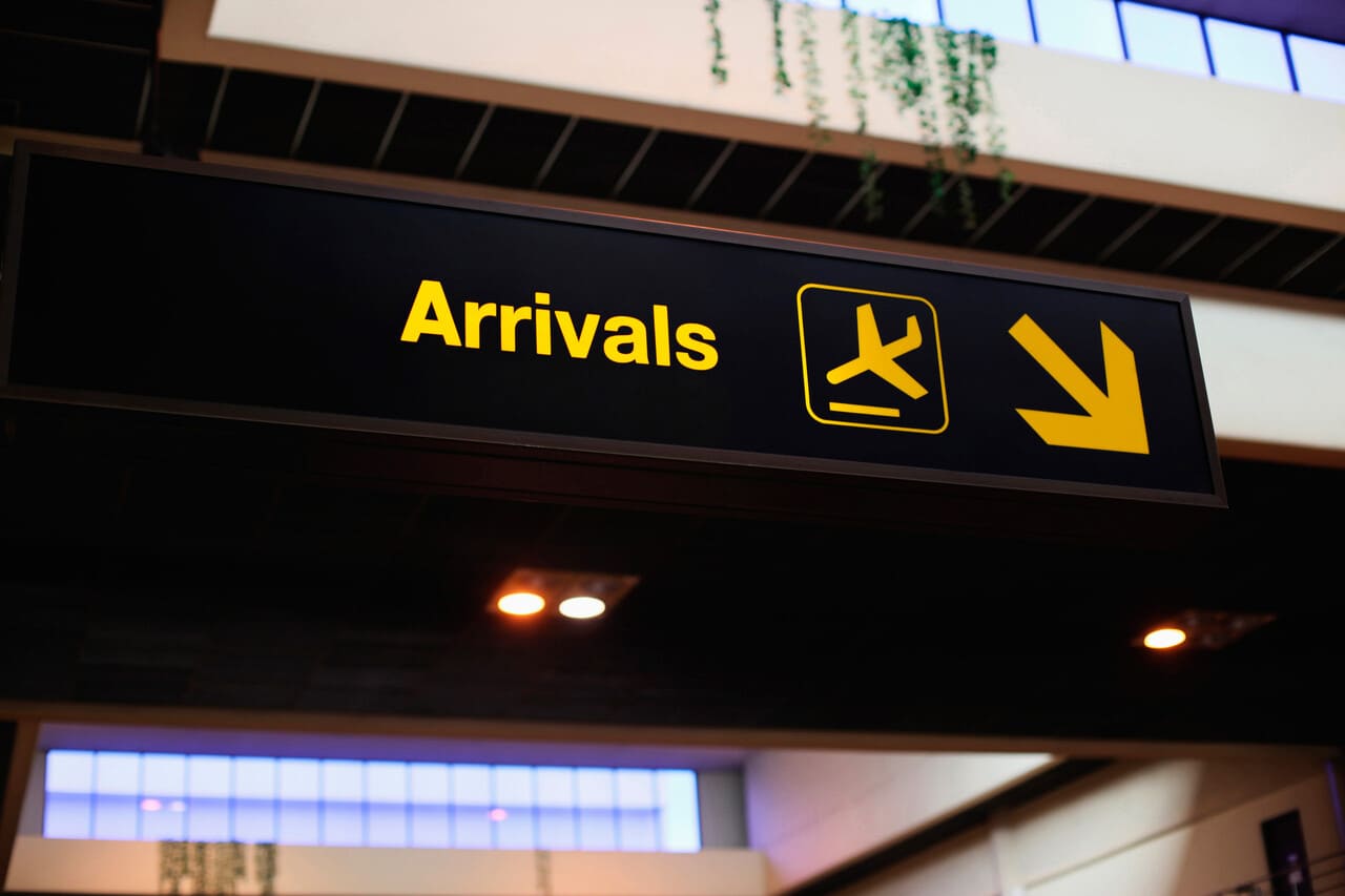 An airport arrival sign or terminal display referencing Hawai‘i,