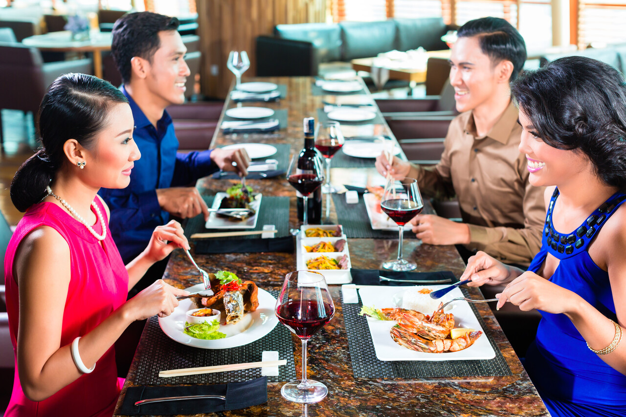 Asian Friends eating in restaurant
