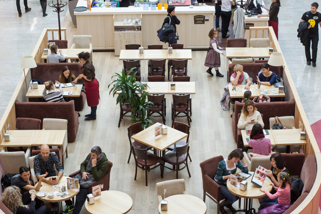 An interior shot of a restaurant, office lobby, or retail store with people dressed neatly and casually.