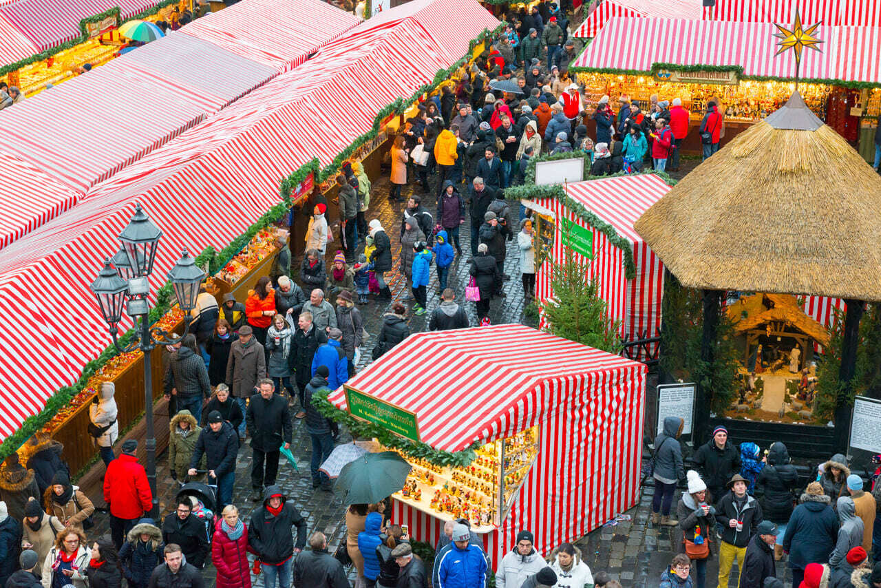 A marketplace scene with crowds gathering for winter festivities.