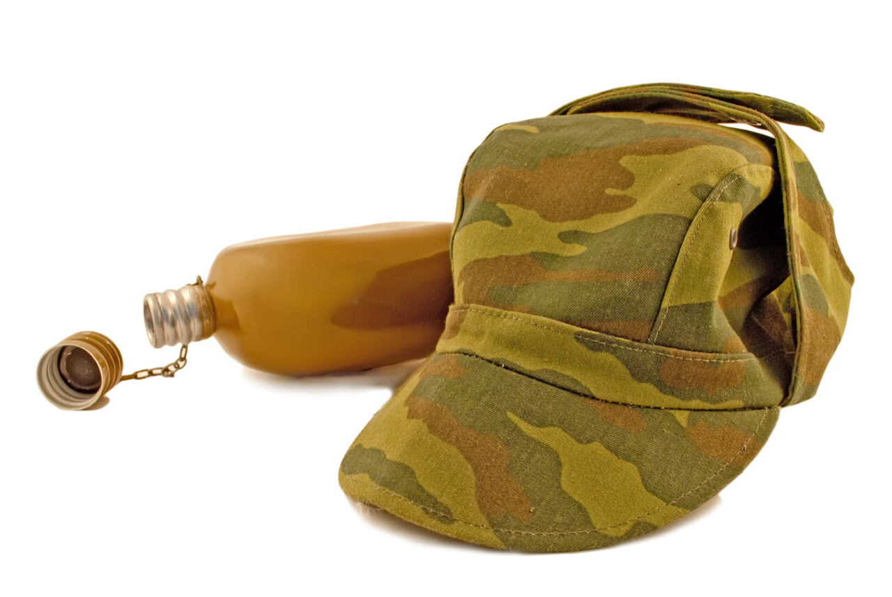 A military cap placed on a flat surface.