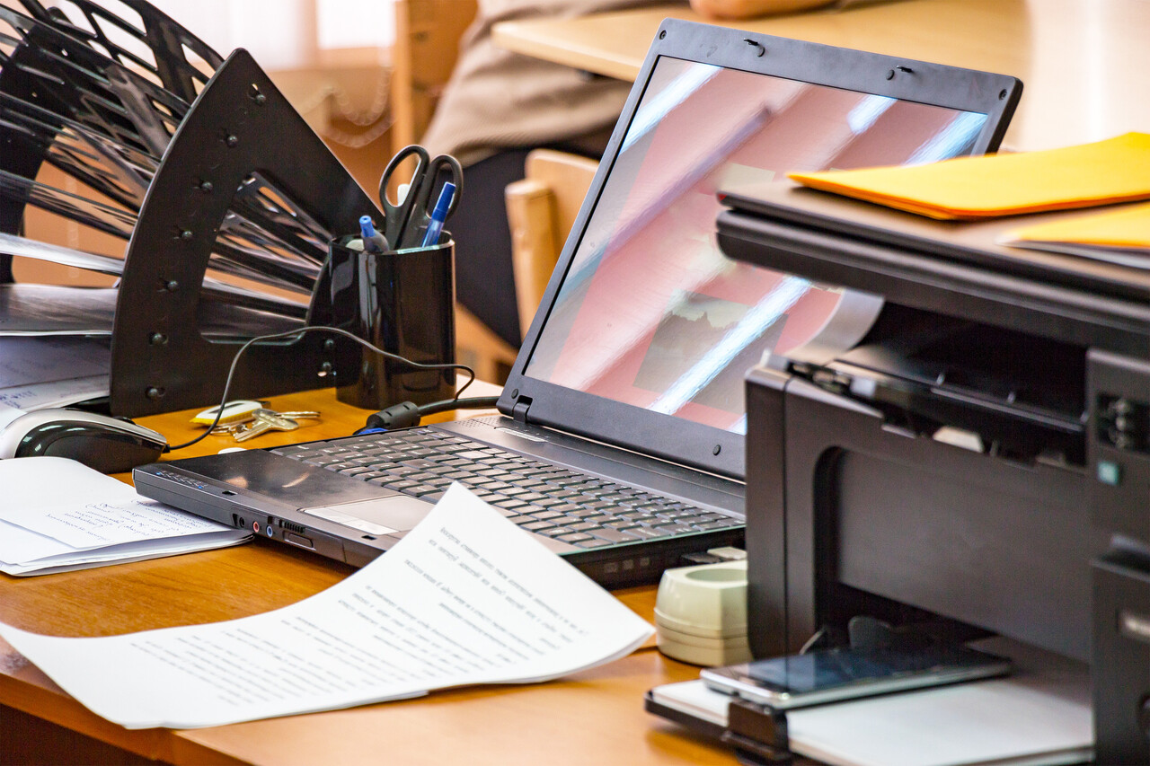 A film-editing desk with marked workprint strips and handwritten timing sheets scattered next to a flatbed viewer.
