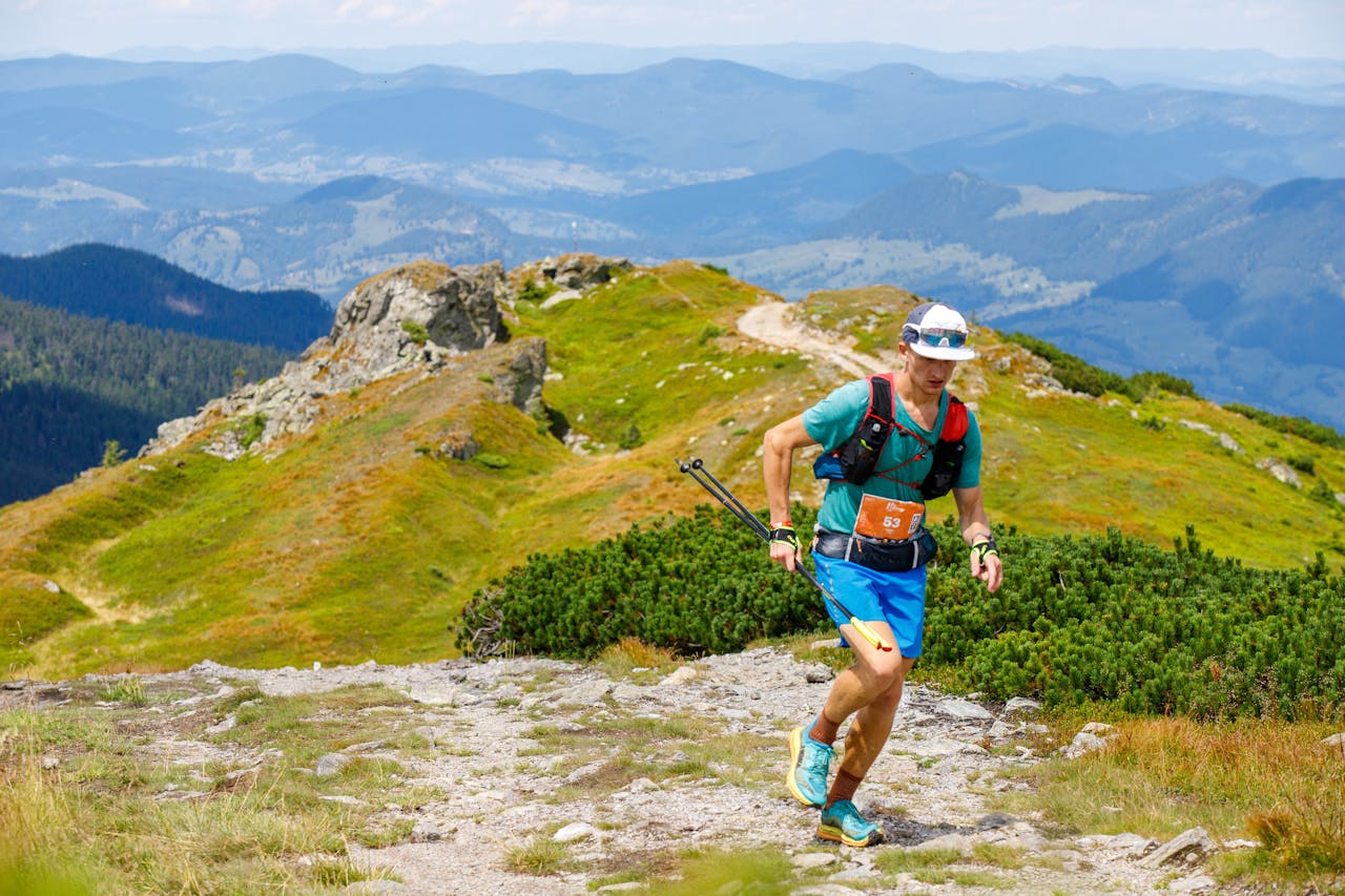 A rugged mountain trail or athletic training area that conveys momentum, determination and physical drive.