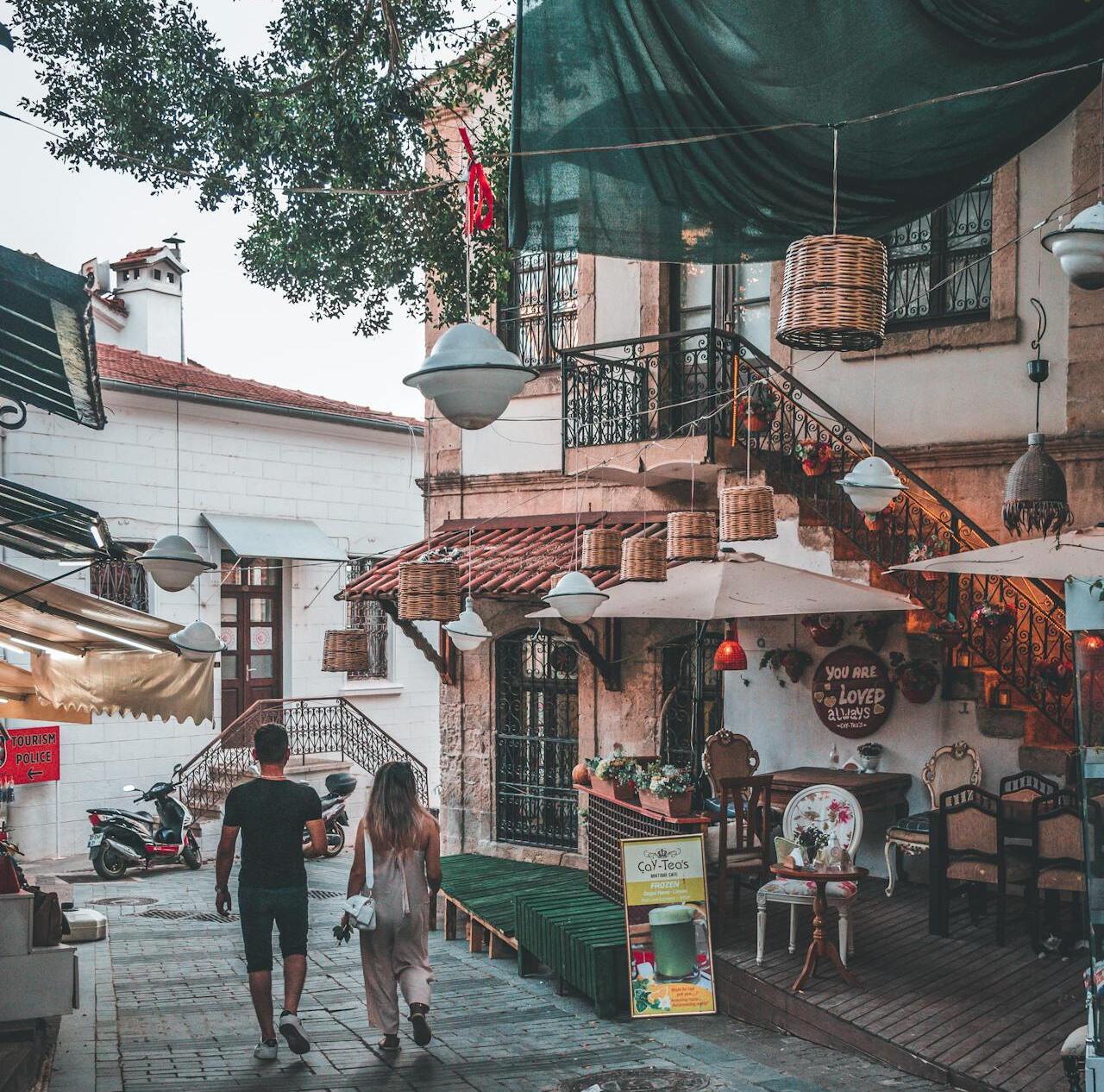 A couple strolling through a small village piazza
