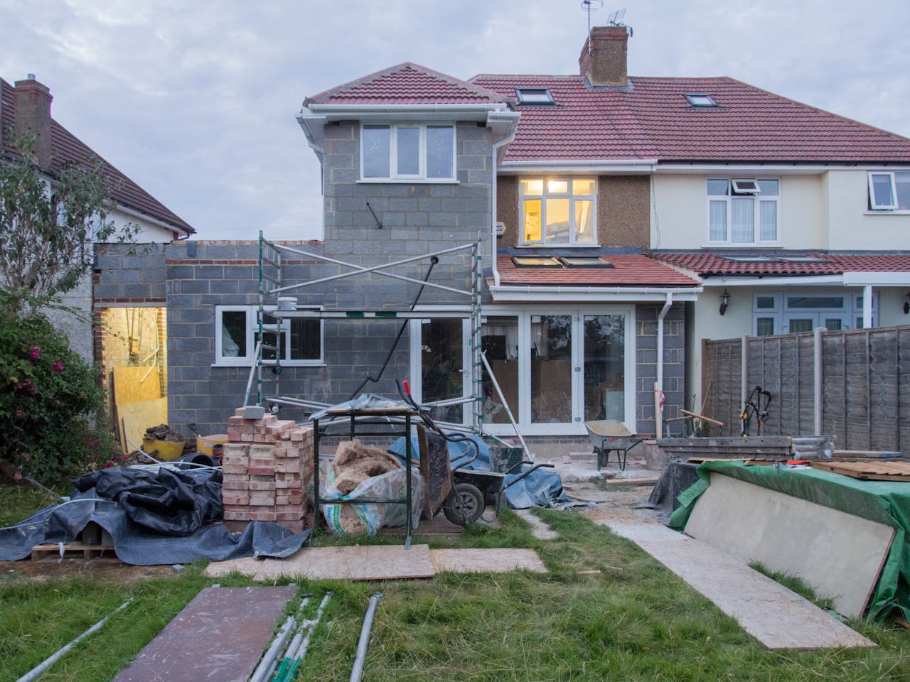 Suburban home with visible addition under construction