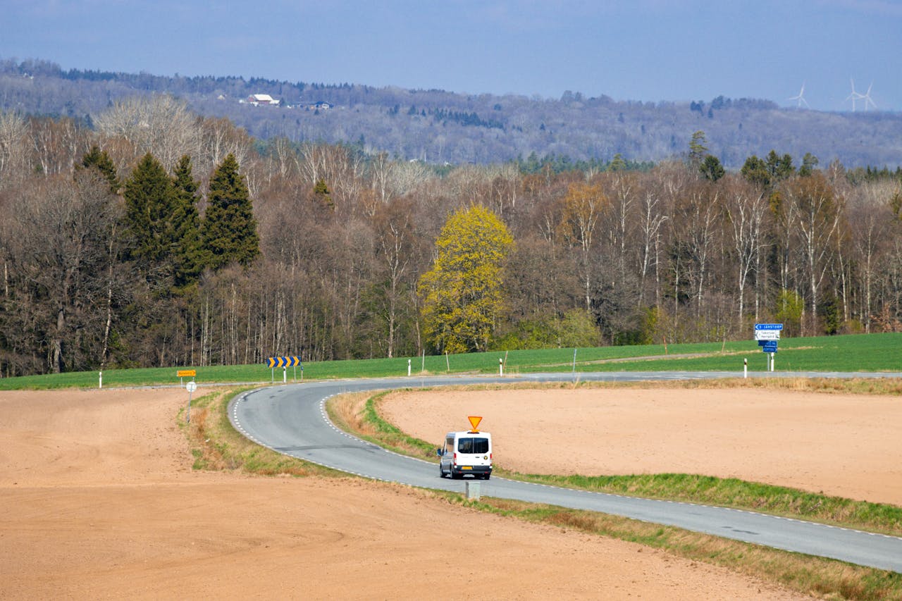 A rural Swedish road lined with forests.