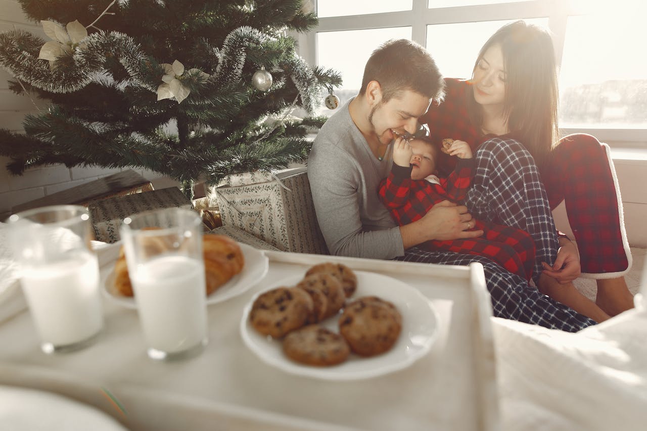 A child leaving cookies and milk near a fireplace