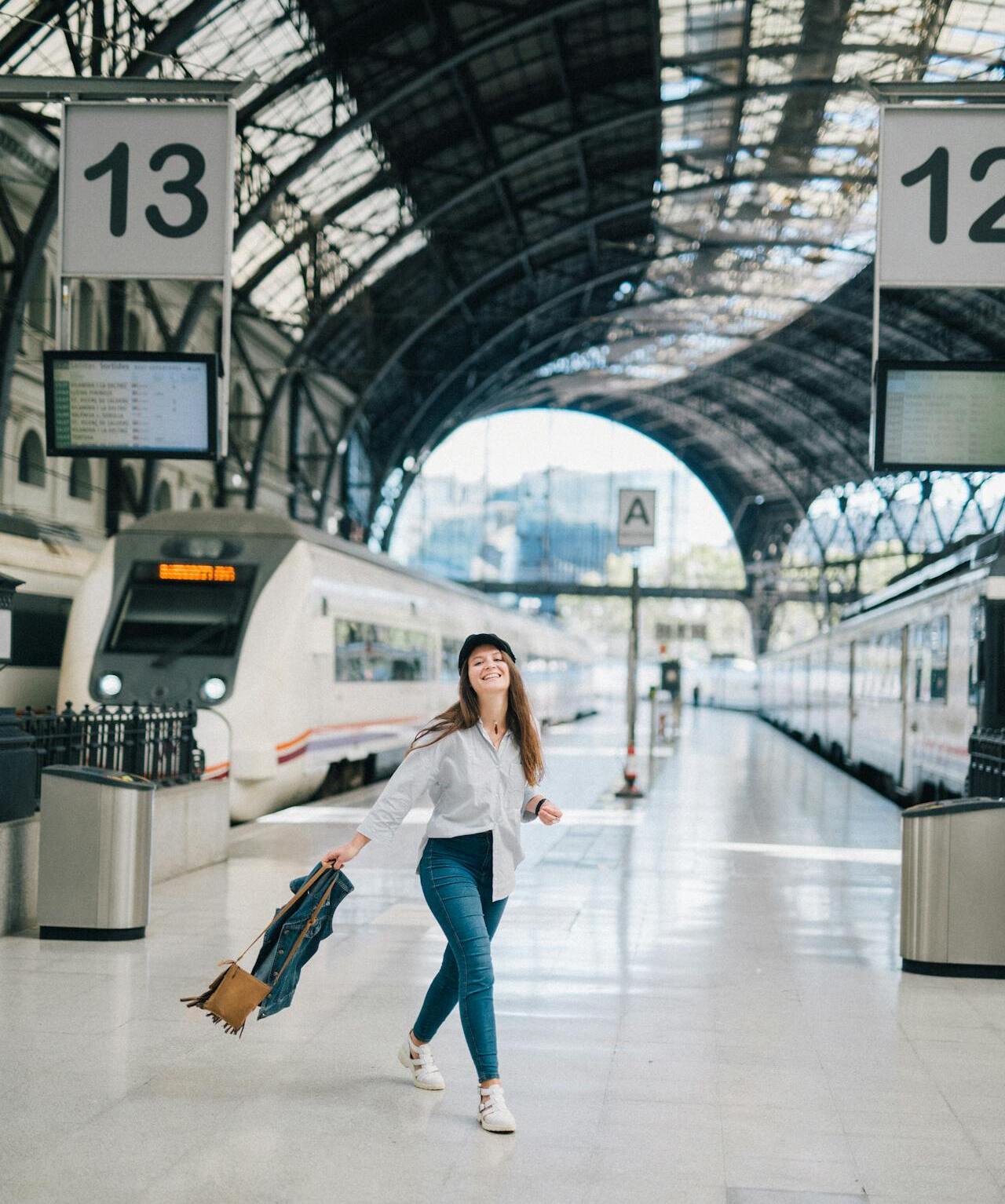 A clean, modern Singapore train platform with clear no smoking signs near waiting areas.