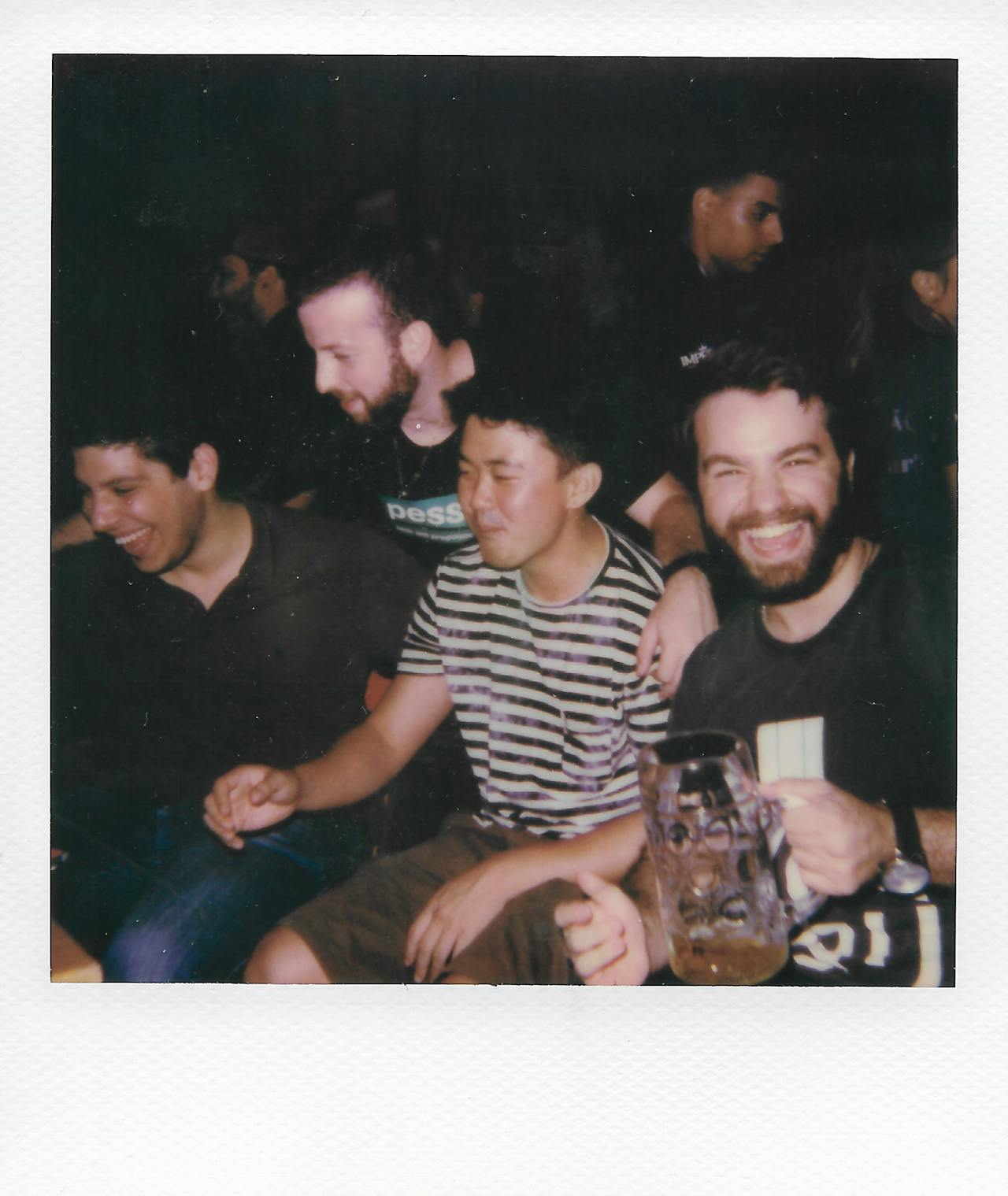 A moody photo of a group of friends laughing together,