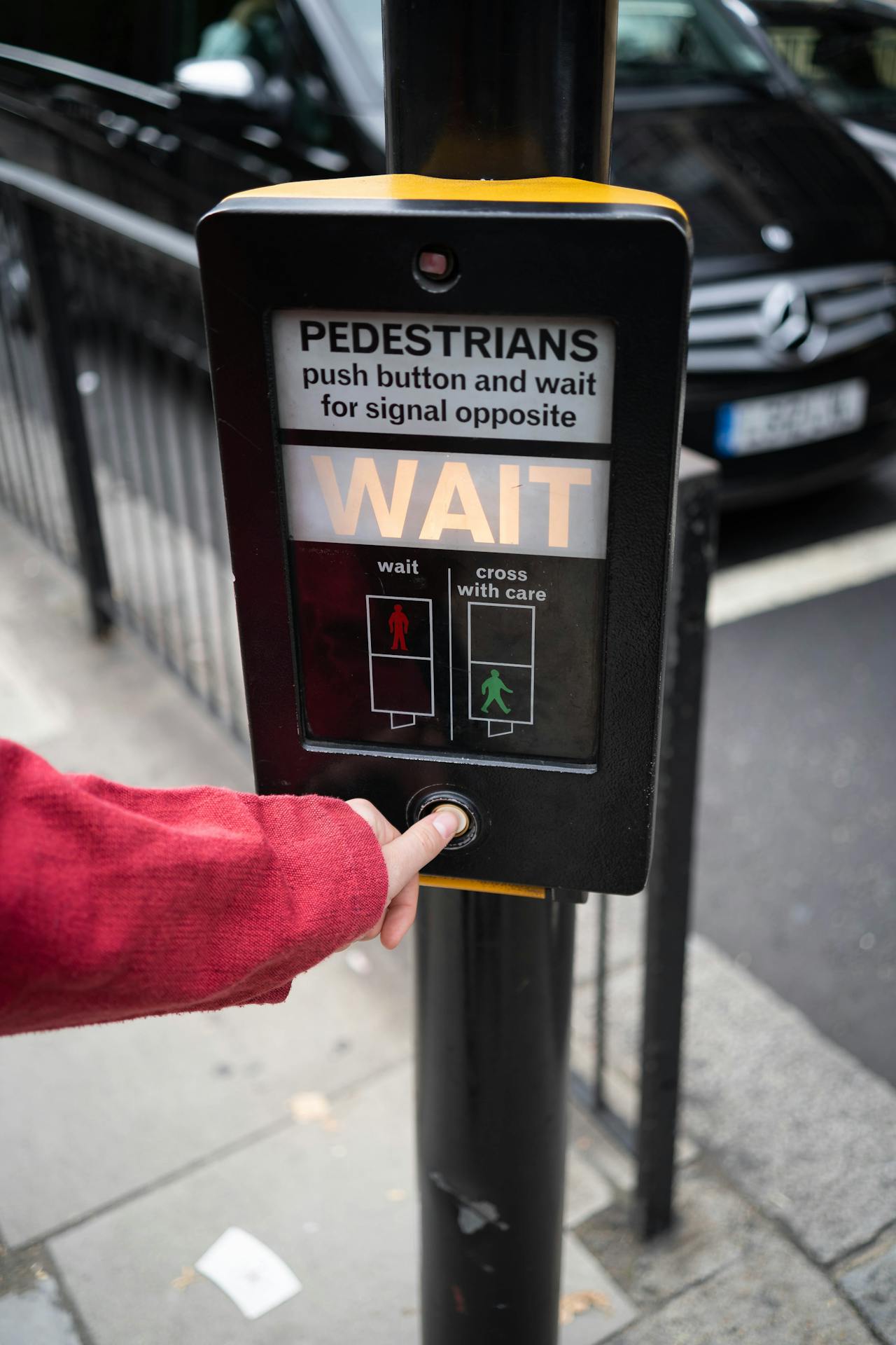 A German pedestrian crossing with the familiar red and green Ampelmännchen signal visible.