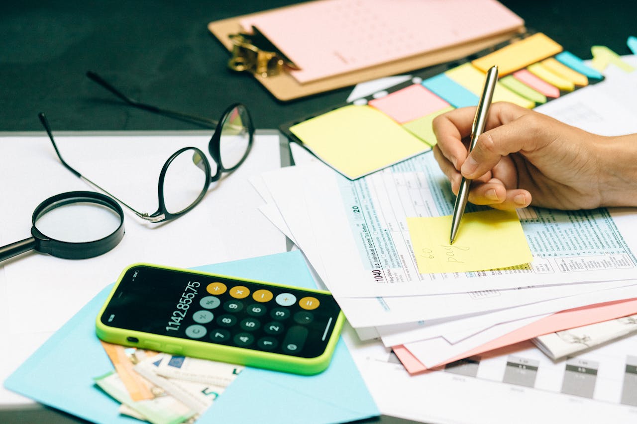 Notes or sticky notes comparing expenses.