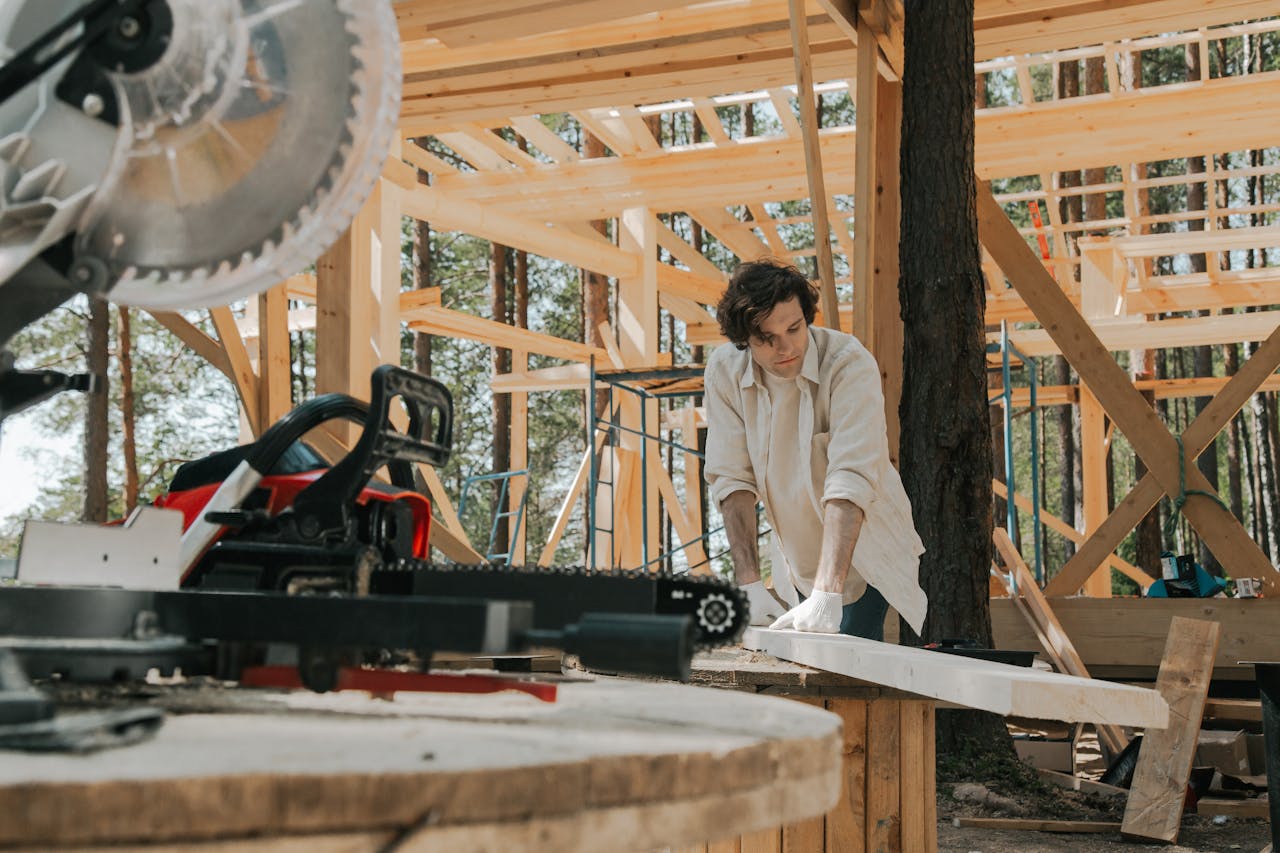 A backyard shed under construction with tools and lumber in view.