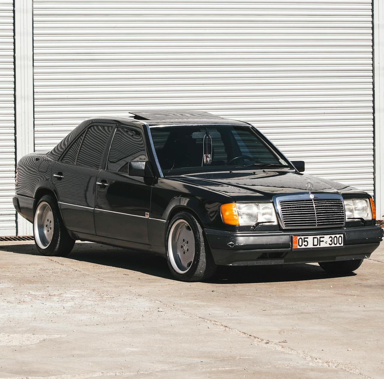 A parked car with a sunroof open,