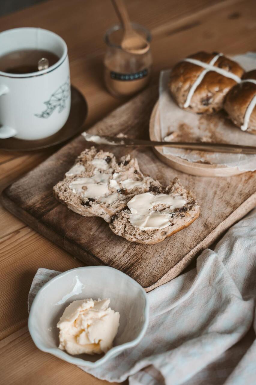A rustic kitchen scene with butter on a cutting board near a stove.