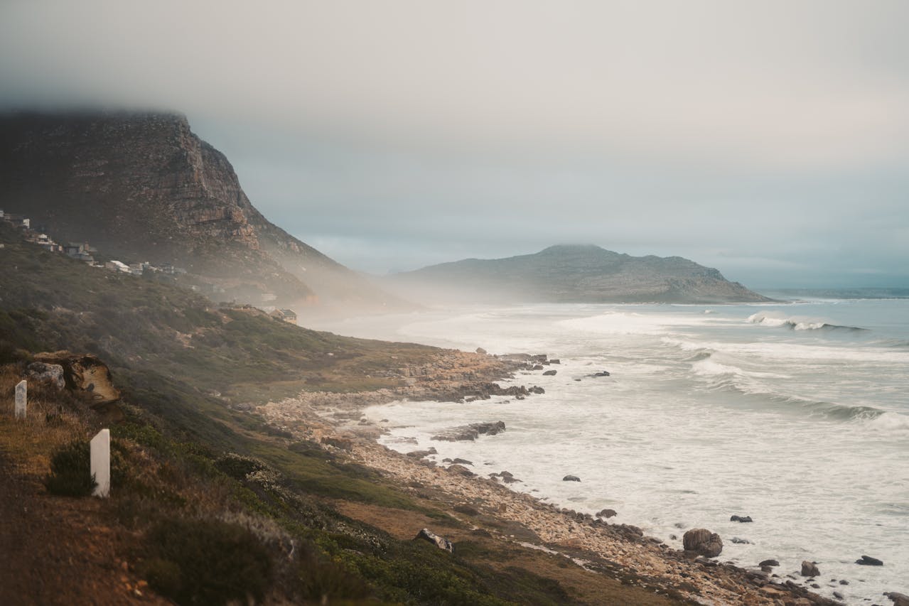 A misty coastline or soft morning fog over water