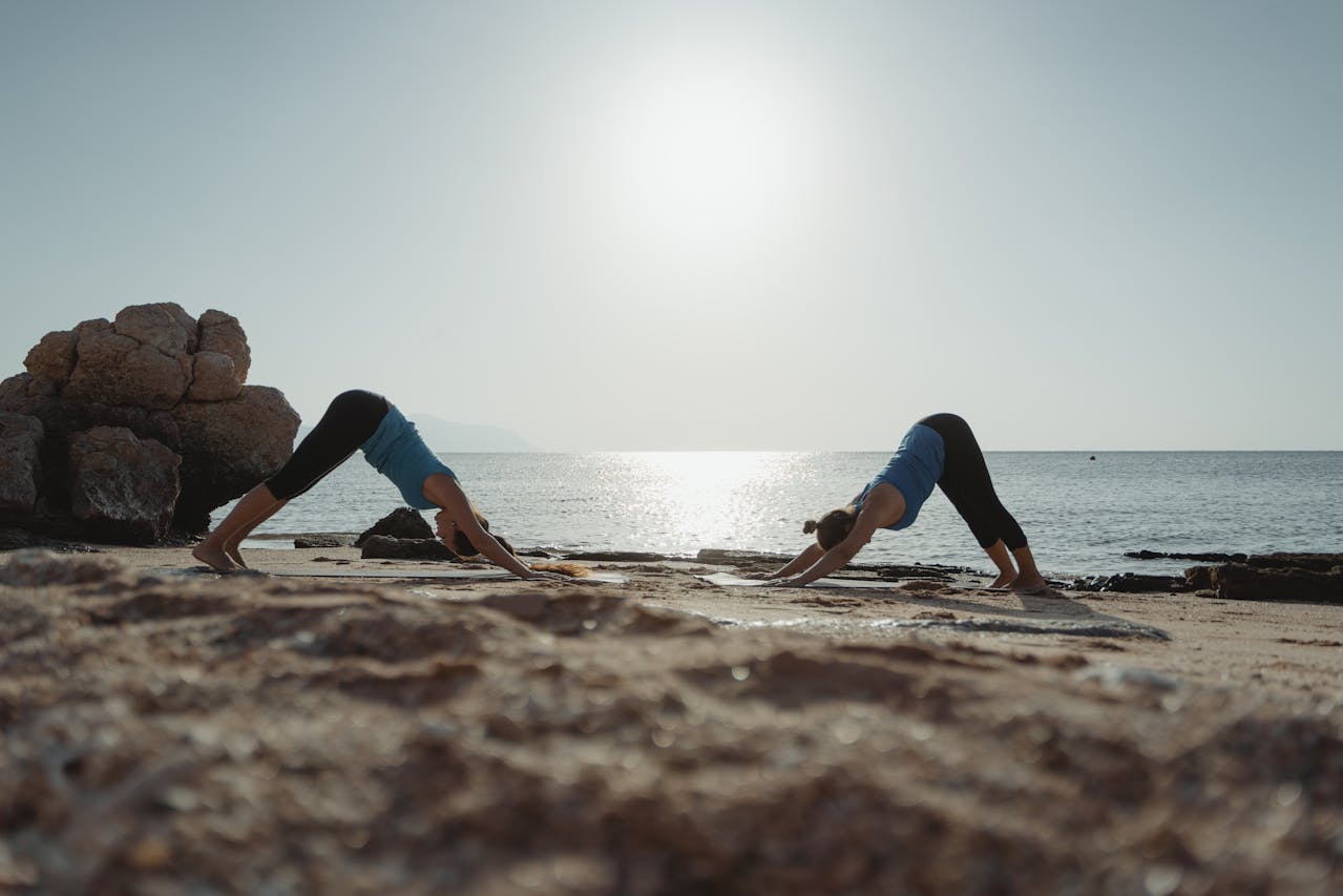 A serene beach at sunrise, a yoga pavilion near the water