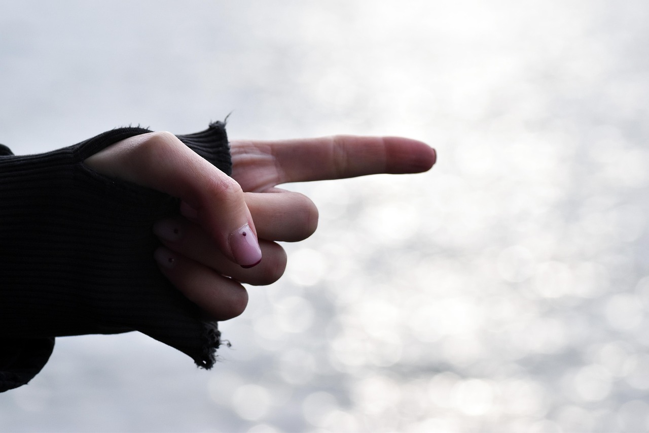 Person indicating direction with an open hand instead of a finger