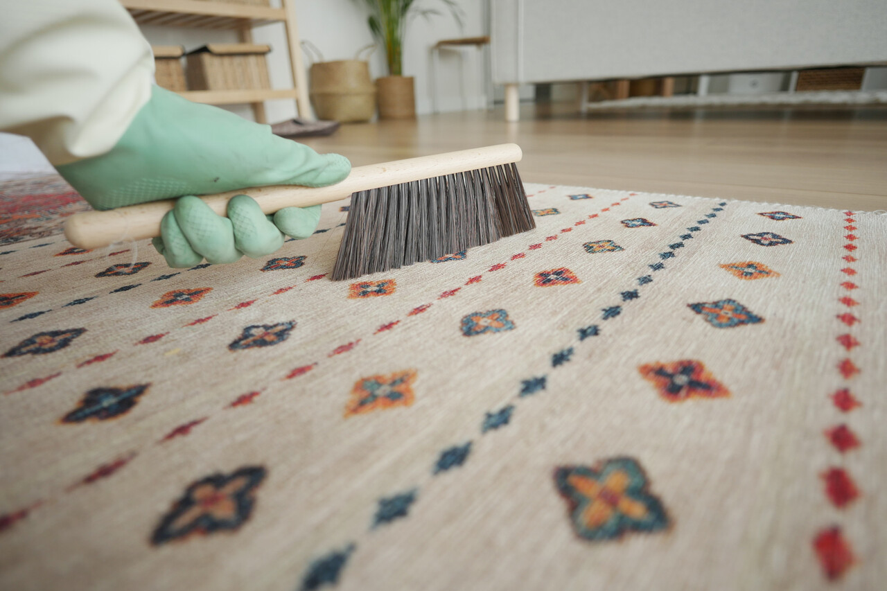 Beating dust out of carpets