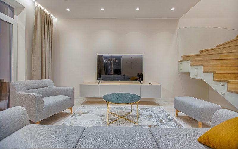 Living room with skirted neutral sofa