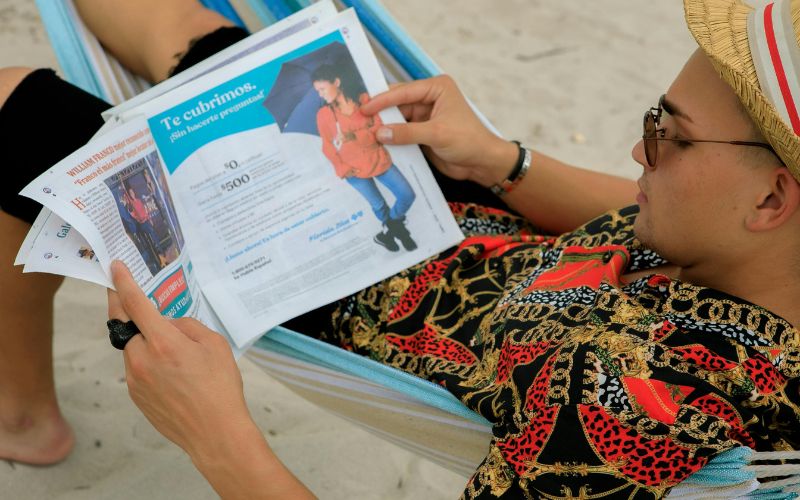 Traveler frustrated while reading fine print of hotel or airline policy