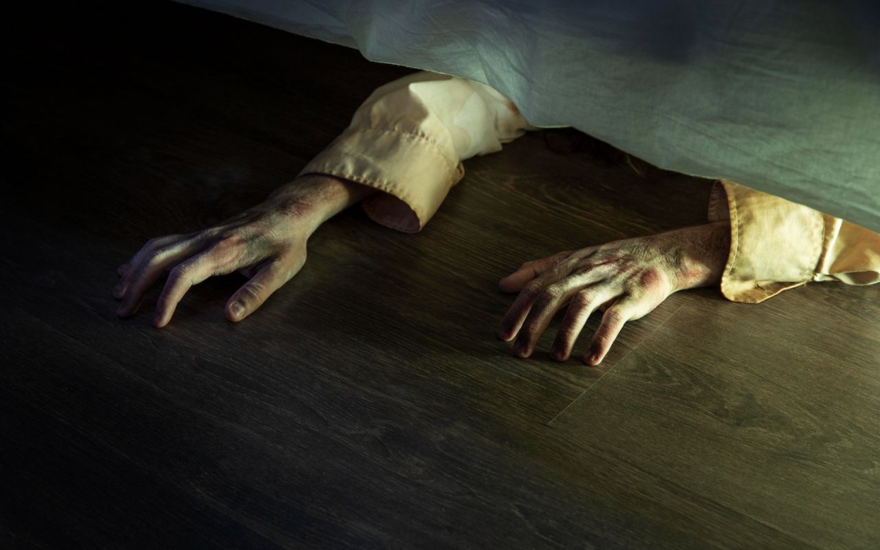 Body Under Hotel Bed