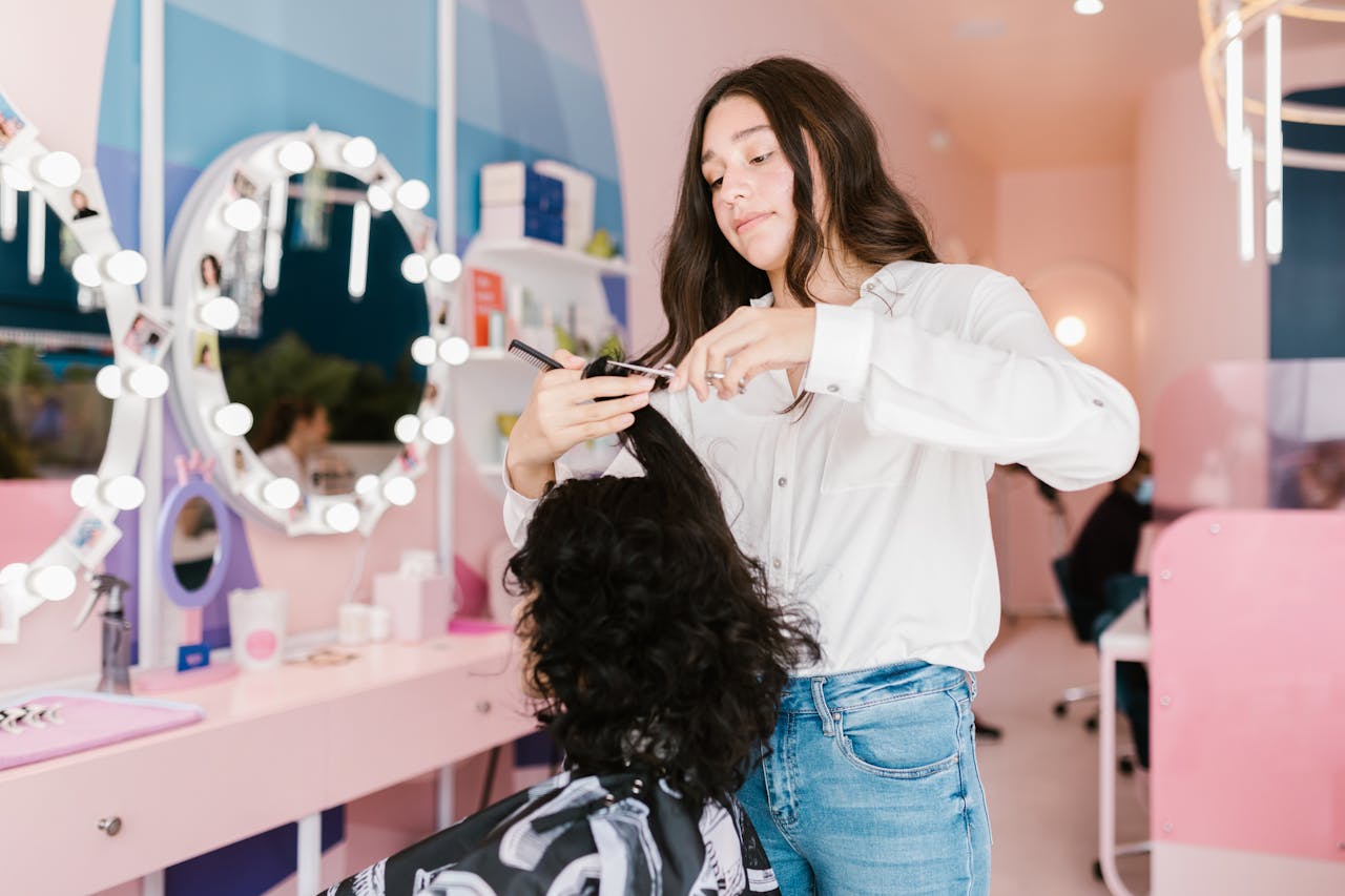 Person attempting a DIY haircut at home with scissors and a mirror