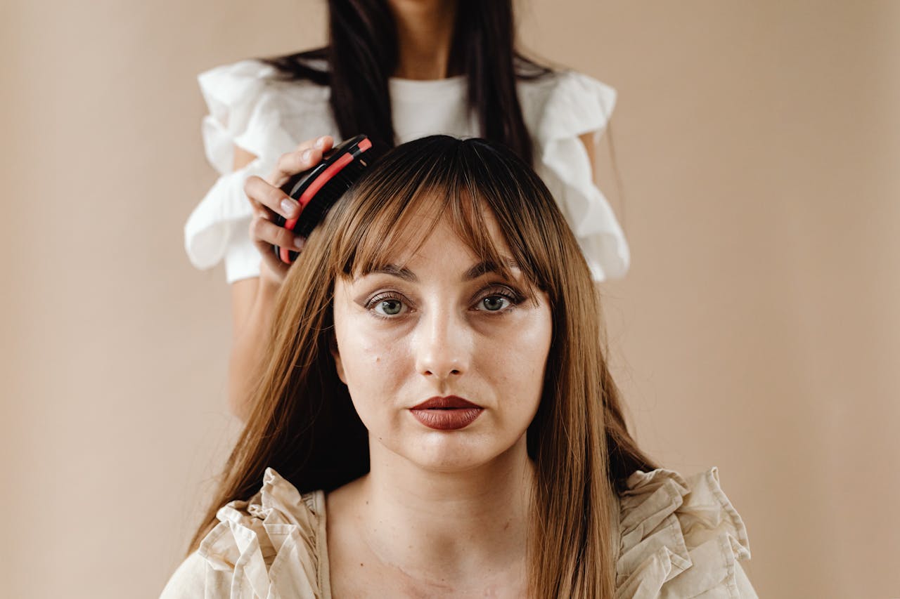 Person preparing hair by brushing and detangling before cutting
