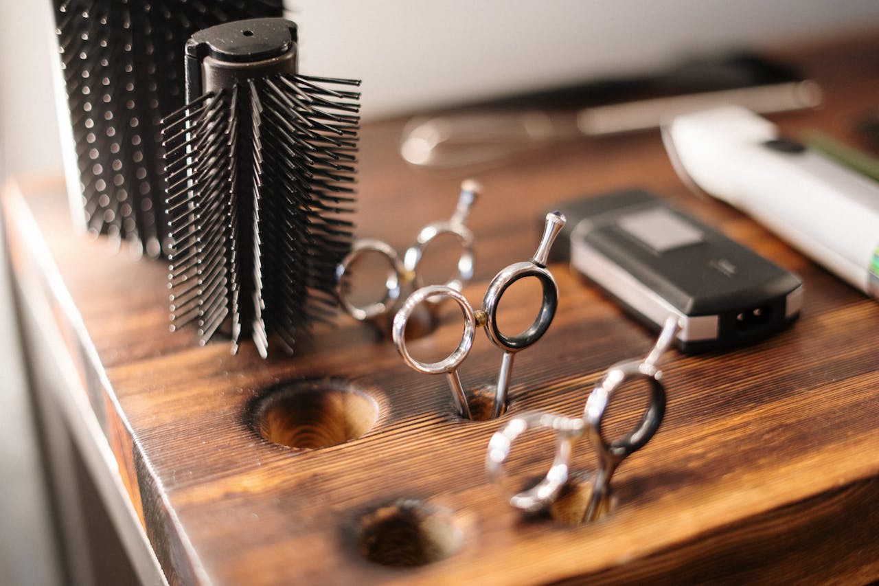 Kitchen scissors next to professional hair scissors and a comb