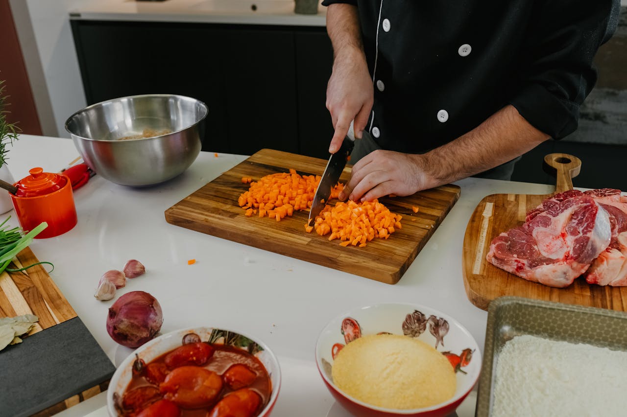 Chef substituting ingredients in a professional kitchen during prep.