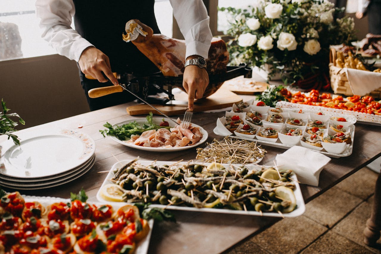 Chef placing fresh herbs and sauce on a plated dish before service.