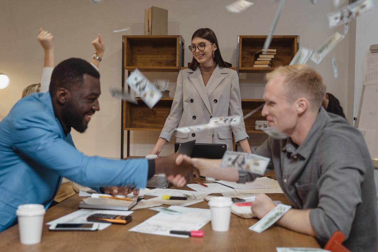 A professional standing slightly apart with arms at their sides while another extends a hand, capturing the awkwardness of skipping a handshake.