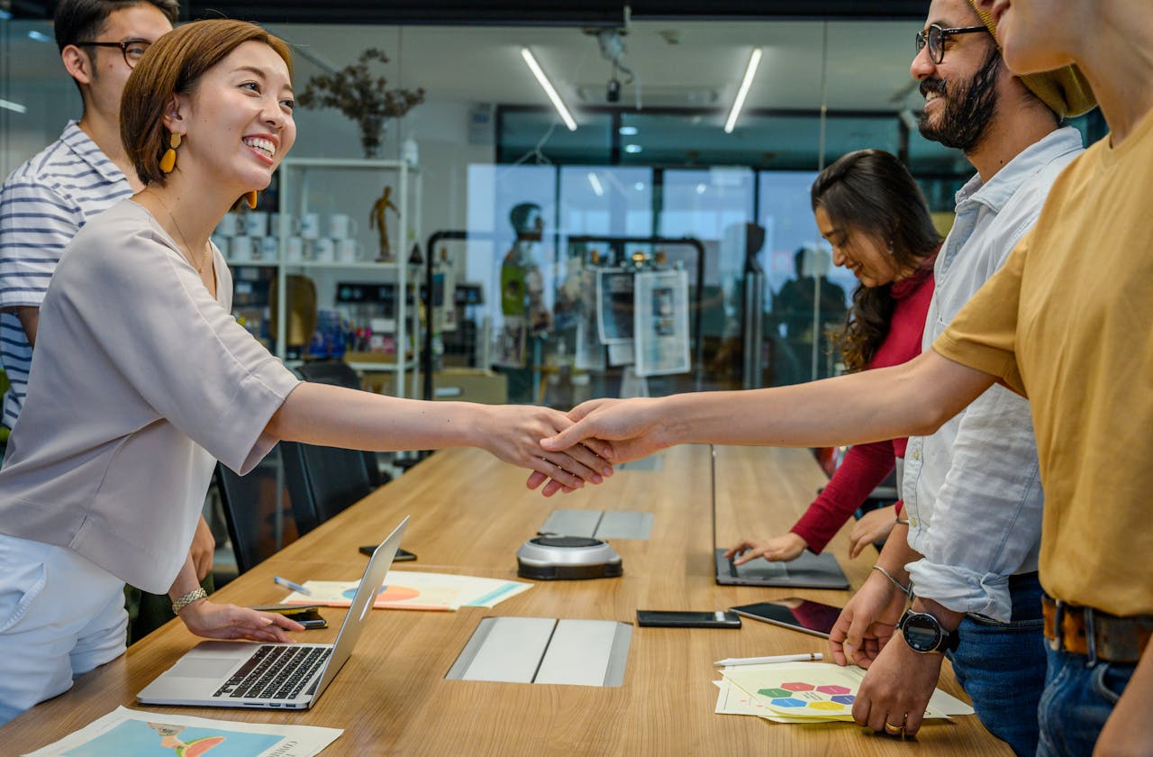 A handshake where one person looks away while the other maintains eye contact, showing the impact of missing visual connection.