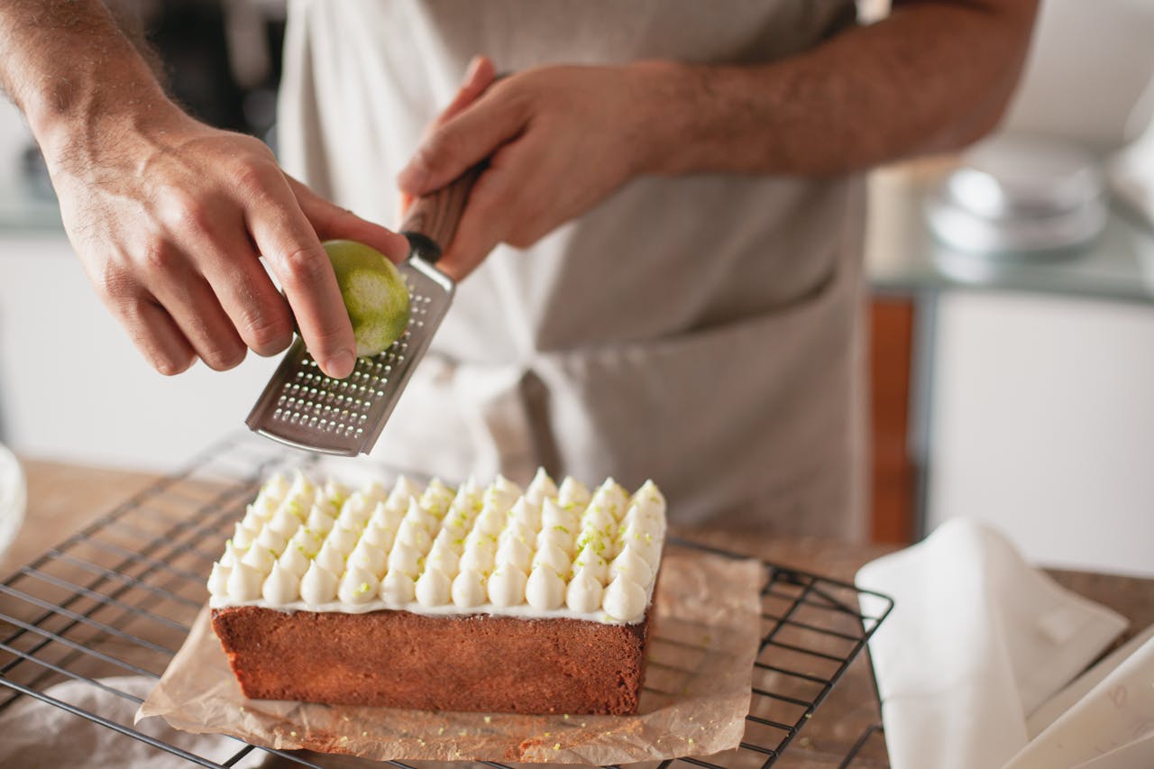 A chef finishing a scratch-made dessert using partially prepared ingredients.